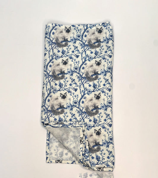 Folded scarf with Birman cat pattern on a white background