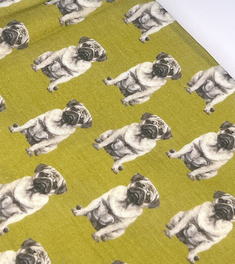 Pattern of pugs on a green scarf fabric background