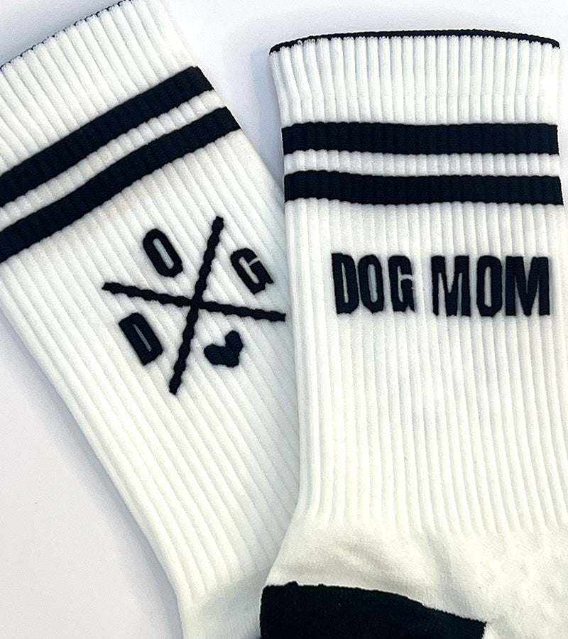 White socks with black stripes and 'DOG MOM' text on a white background