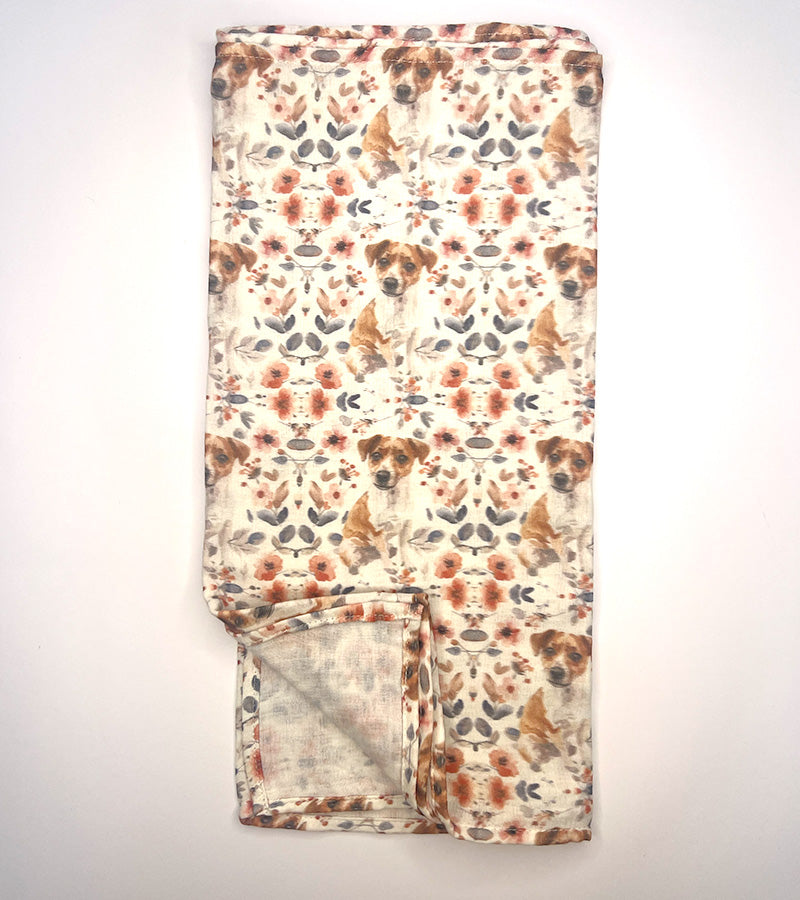 Floral and Jack Russell dog patterned blanket on a white background