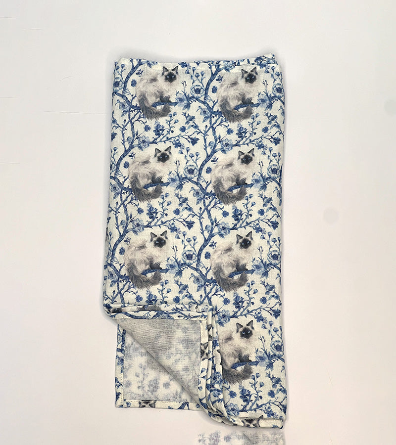 Folded scarf with Birman cat pattern on a white background