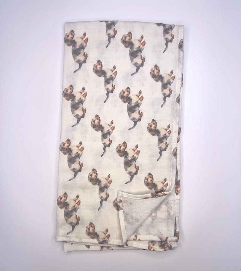 Folded scarf with Dachshund dog pattern on a white background