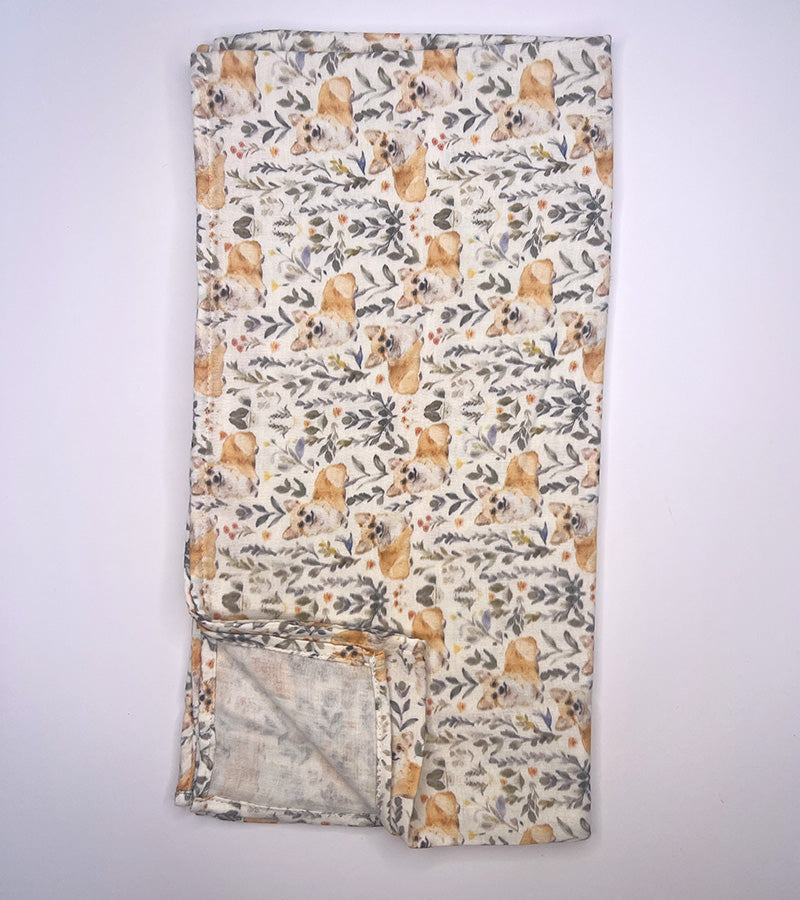 Floral-patterned and dog patterned scarf on a white background