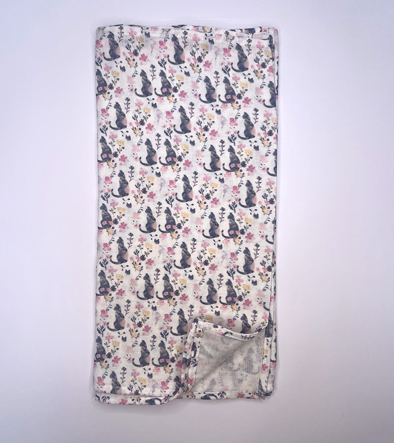 Floral patterned blanket with cat design on a white background