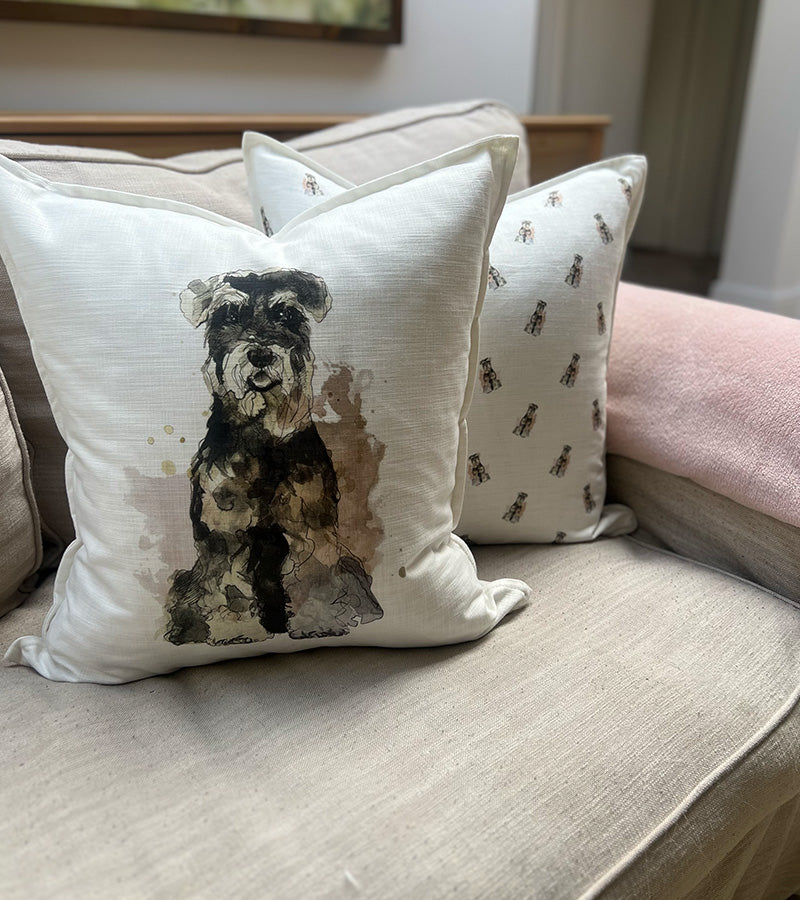 Schnauzer dog designs on a white cushion on couch