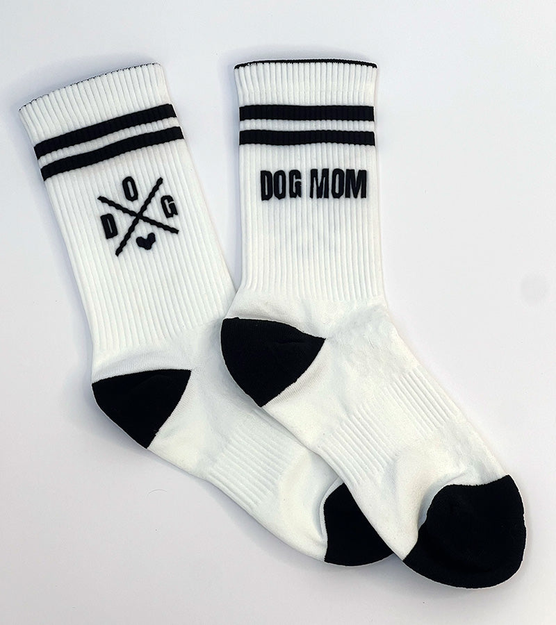 White socks with black stripes and 'DOG MOM' text on a white background