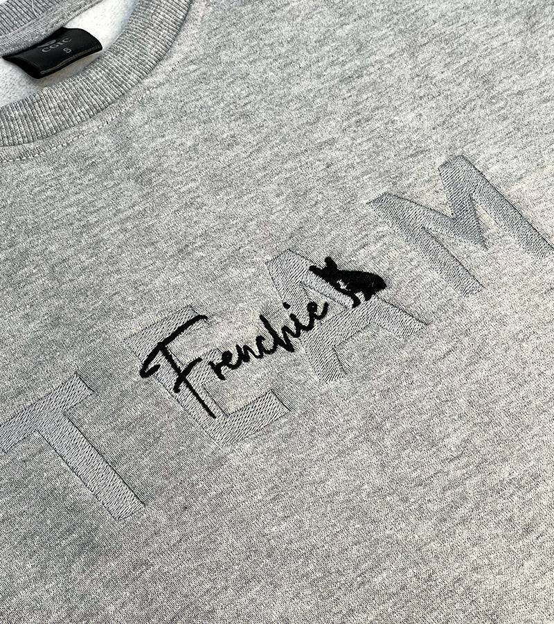 Gray sweatshirt with 'TEAM Frenchie' text and dog silhouette image on a plain background