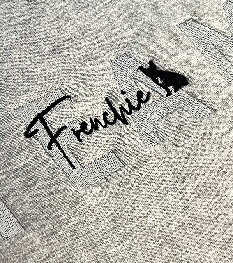 Gray sweatshirt with 'TEAM Frenchie' text and dog silhouette image on a plain background