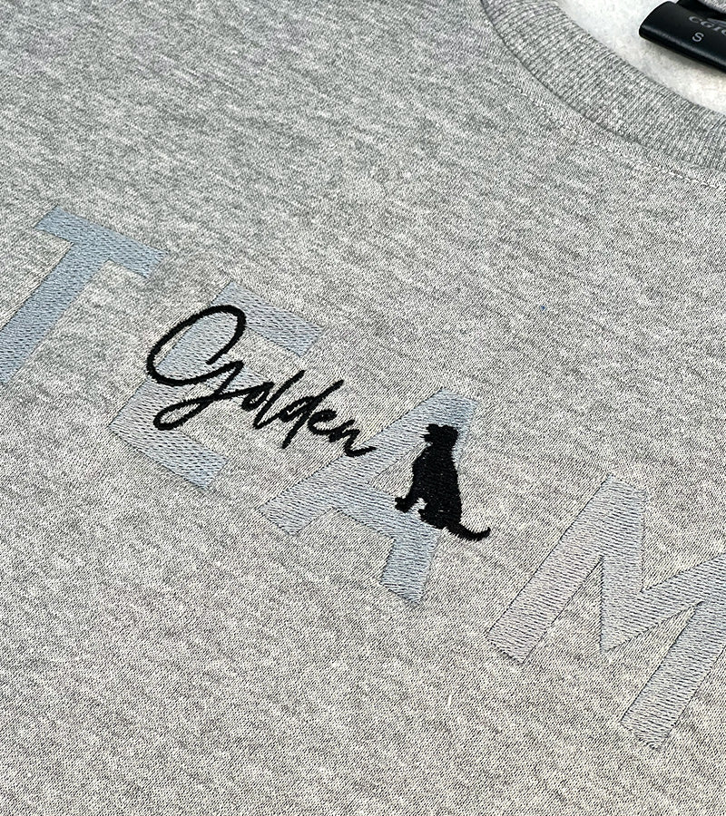 Gray sweatshirt with 'Golden' text and Golden Retriever dog silhouette logo