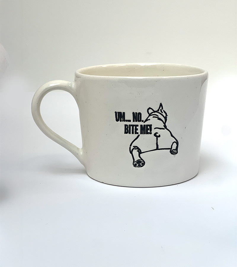 White mug with black 'Um, no. BITE ME!' text and a black dog illustration on a white background