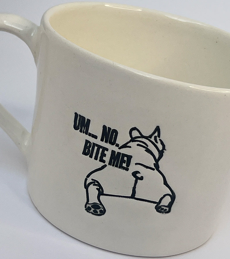 White mug with black 'Um, no. BITE ME!' text and a black dog illustration on a white background