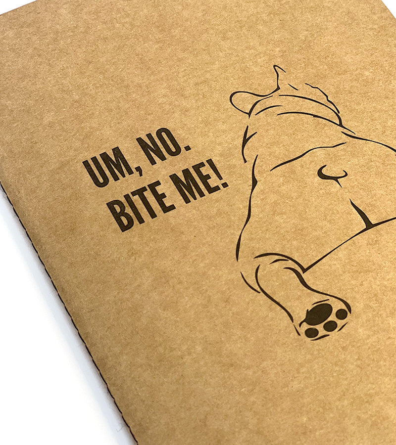 Brown notebook with 'Um, no. BITE ME!' text and a dog illustration on a white background