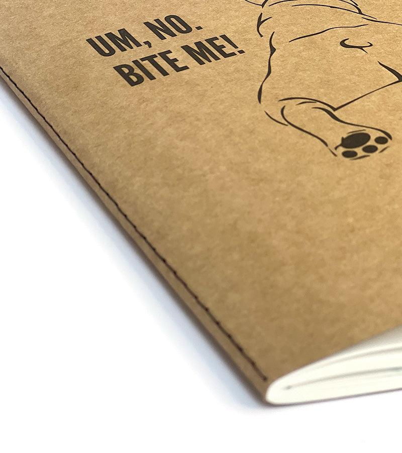 Brown notebook with 'Um, no. BITE ME!' text and a dog illustration on a white background