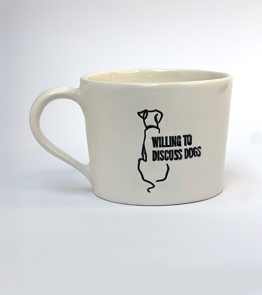White mug with black 'Willing to discuss dogs' text and dog illustration on a white background