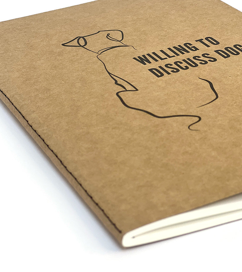 Kraft paper notebook with a dog illustration and 'Willing to Discuss Dogs' text on a white background